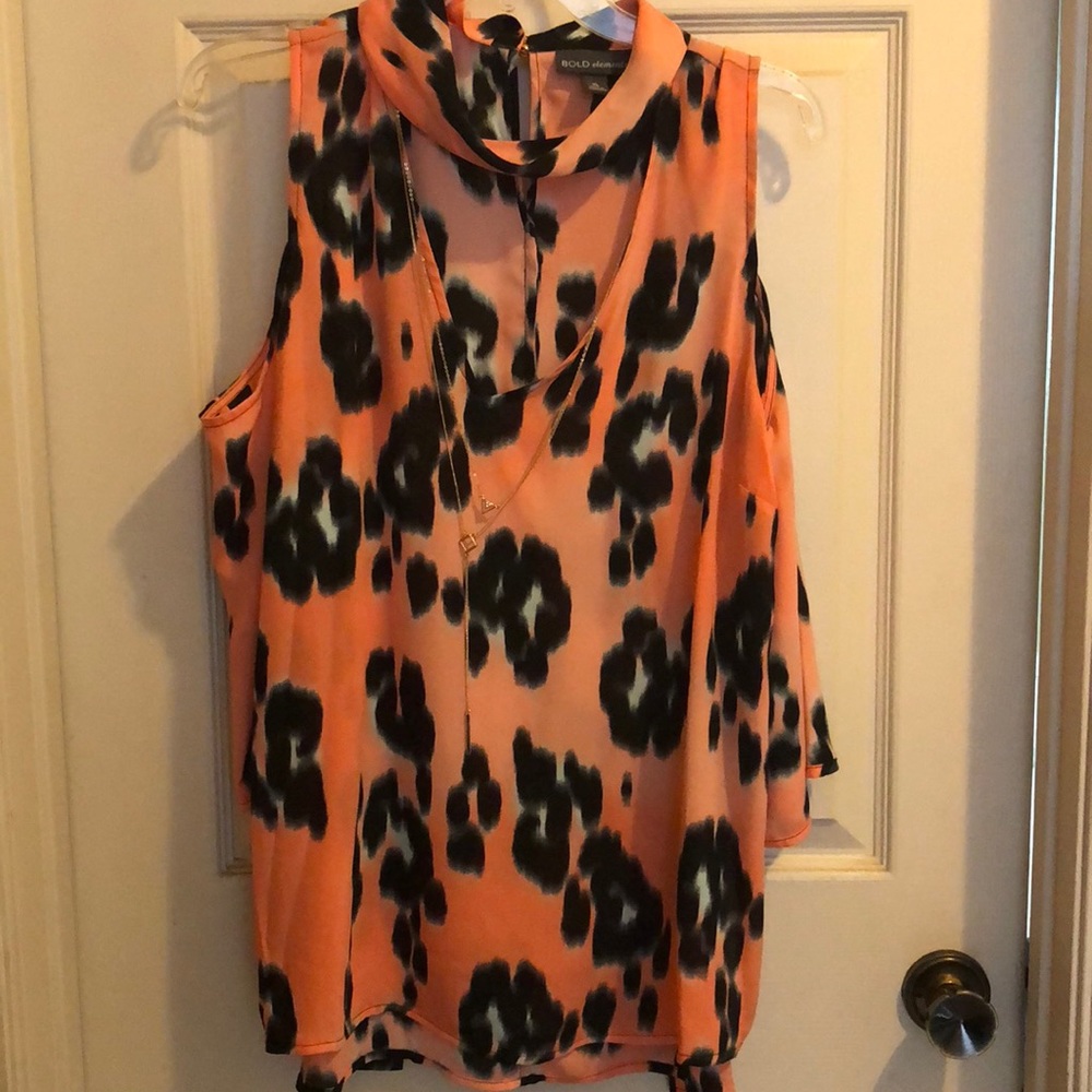 Bold elements black and orange-pinkish top.
